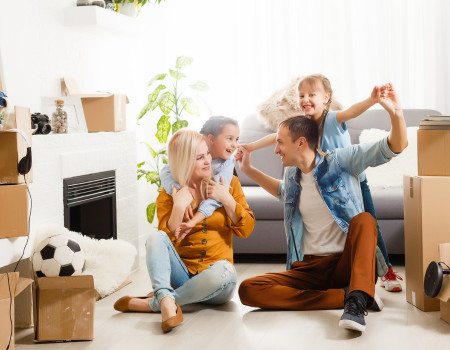 Building inspections Cairns family playing in new home with packing boxes.